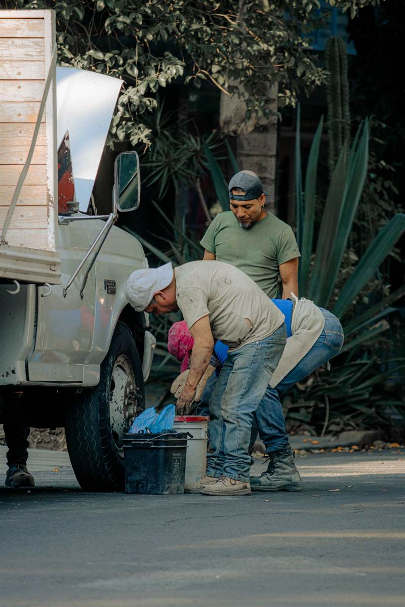 Praxium technicians working together beside a service truck