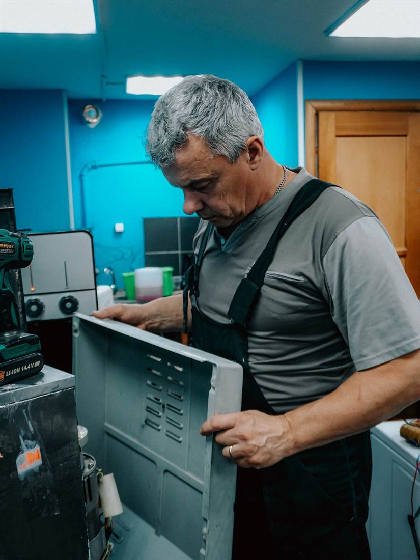 Technician repairing a household appliance